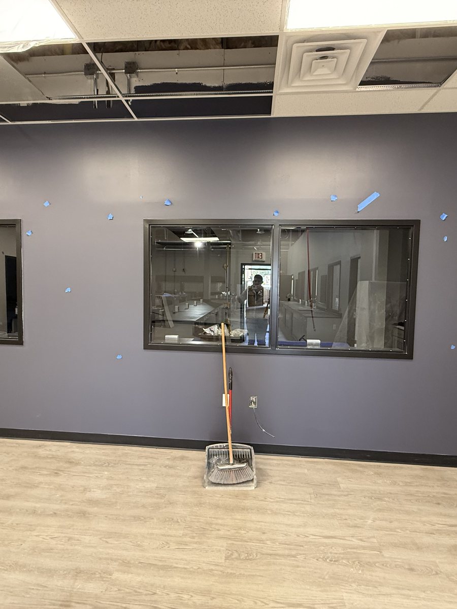 Finished interior with painted walls, acoustic ceiling, interior glazing and plank flooring