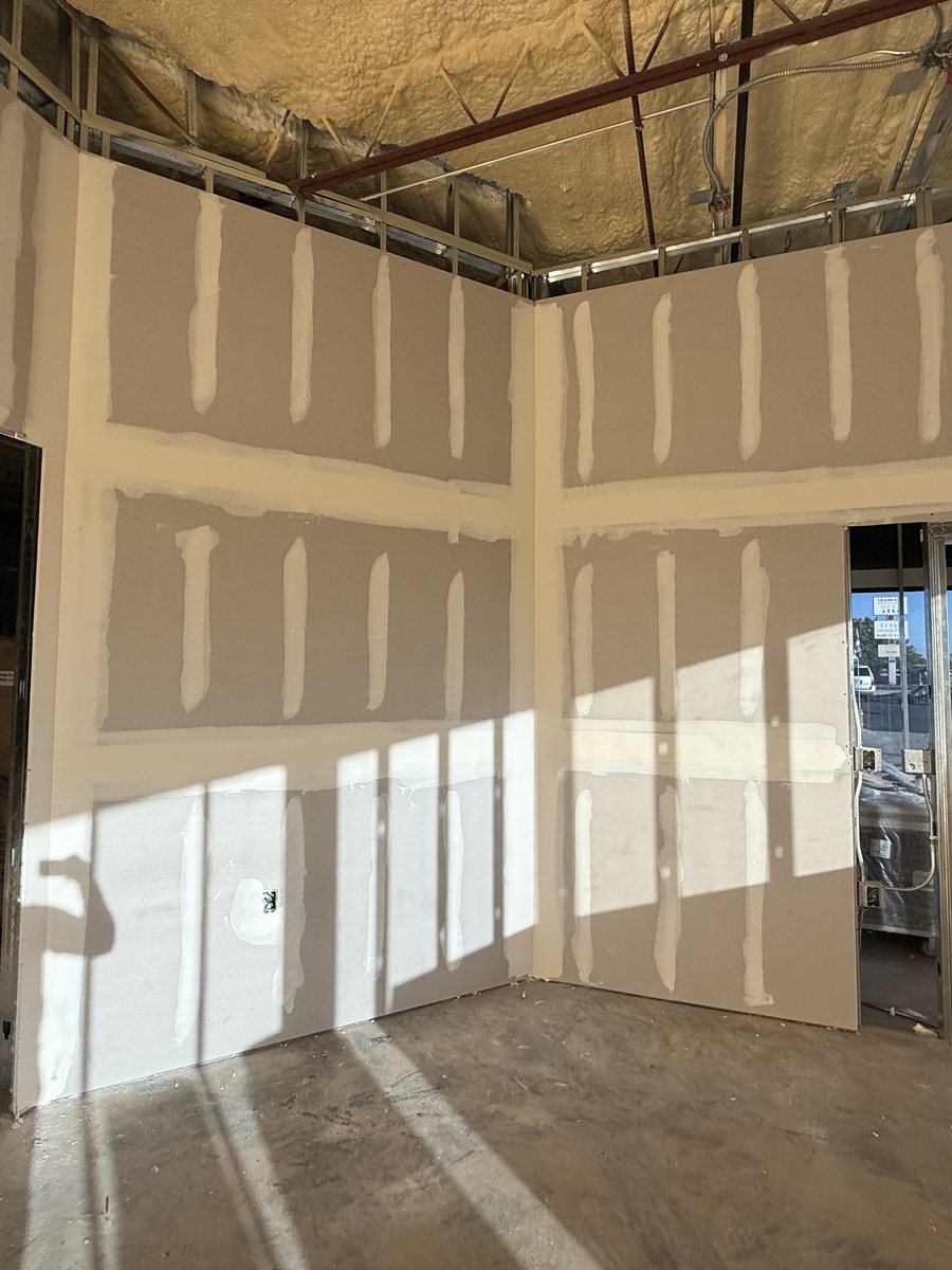 Drywall walls hung and taped in a warehouse buildout