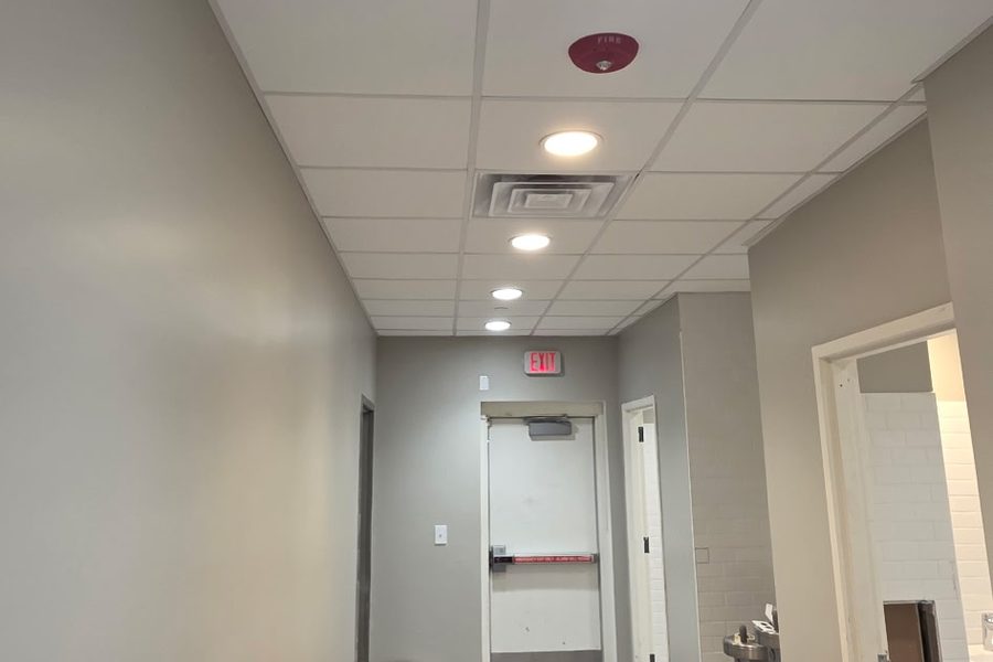 Finished corridor with acoustic ceiling and tile floor